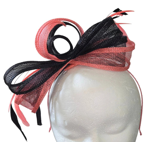 Pink and black decorative headband on a mannequin head with a white background