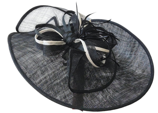 Black and white decorative hat with feather accents on a white background